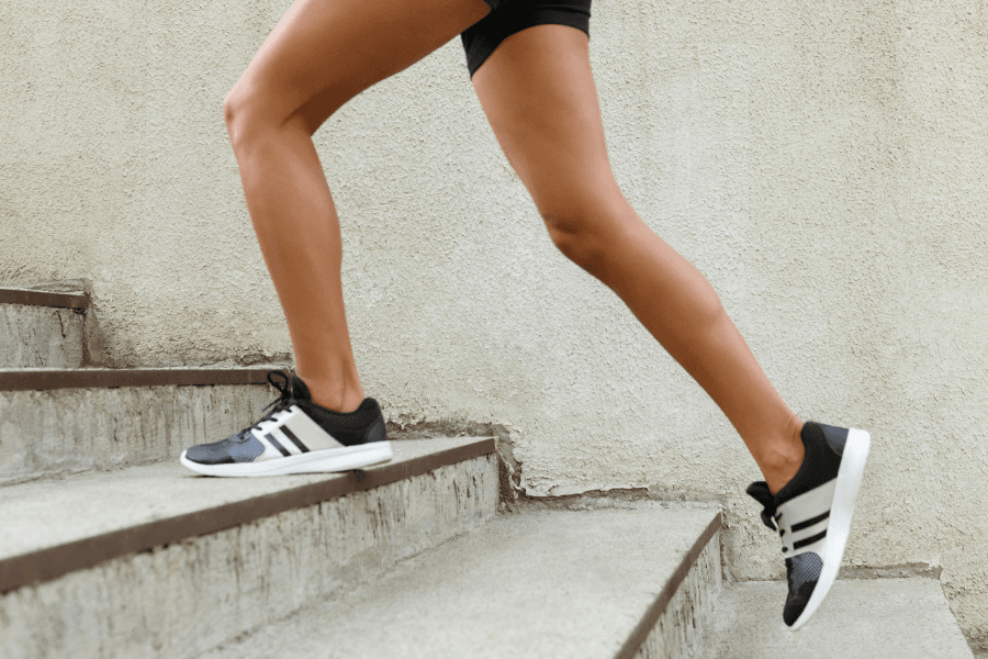 pair of legs jogging up stairs outside